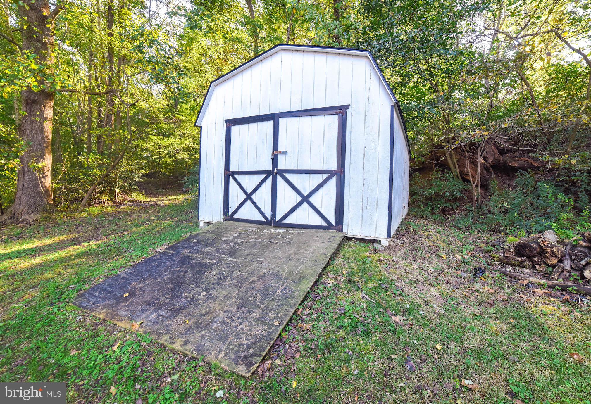 8445 Waverly Road Owings, MD 20736 - Photo 29 of 36 a view of backyard with green space and trampoline
