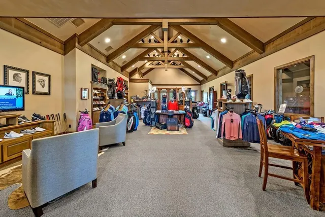 a dining room with furniture a fireplace and wooden floor