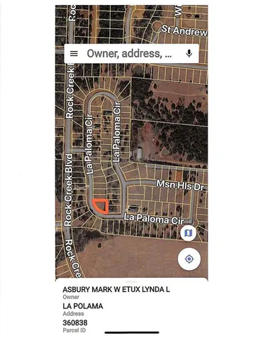 a view of a big yard with large trees