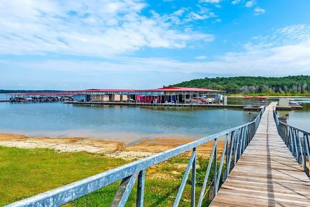 a view of swimming pool with lounge chair in front of house