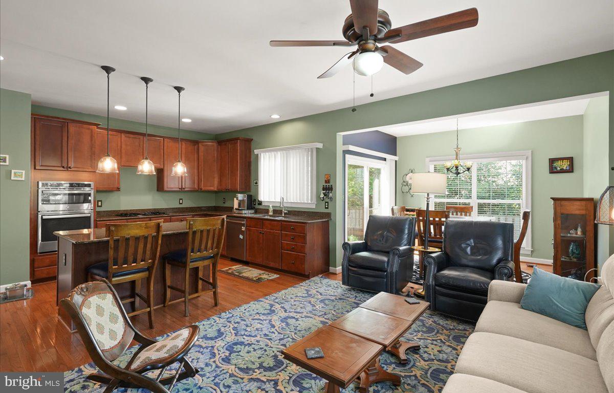 9199 Furey Road Lorton, VA 22079 - Photo 13 of 44 a living room with furniture a ceiling fan and a kitchen