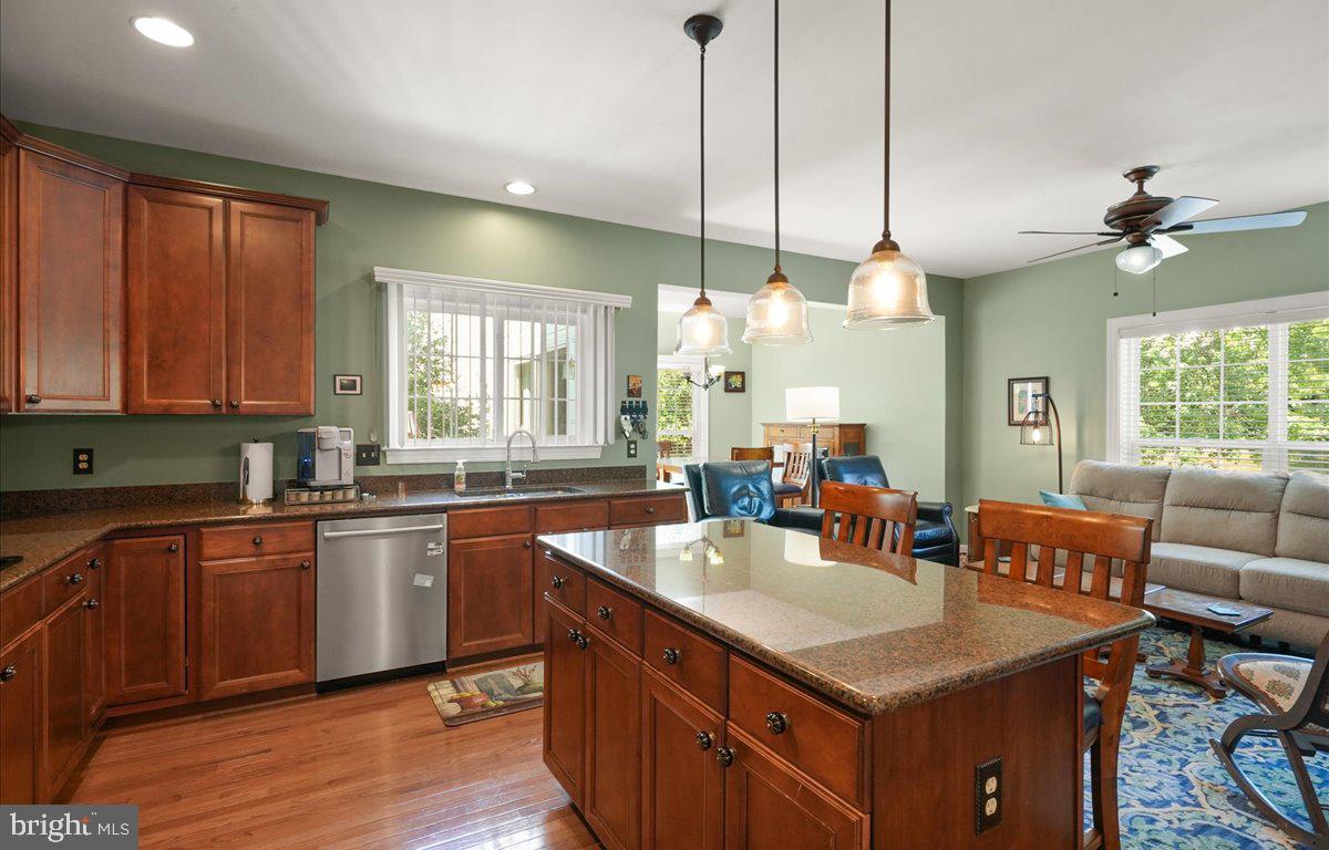9199 Furey Road Lorton, VA 22079 - Photo 16 of 44 a large kitchen with kitchen island a large island in the center a sink a window and stainless steel appliances