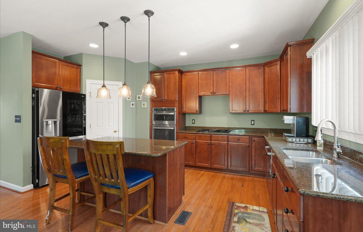 9199 Furey Road Lorton, VA 22079 - Photo 18 of 44 a kitchen with stainless steel appliances granite countertop sink refrigerator and cabinets