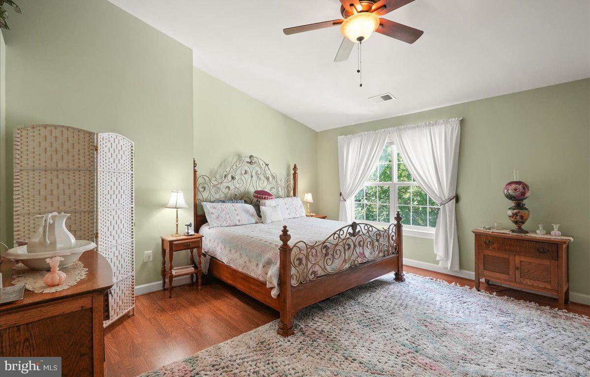 9199 Furey Road Lorton, VA 22079 - Photo 22 of 44 a bedroom with a bed and a chandelier