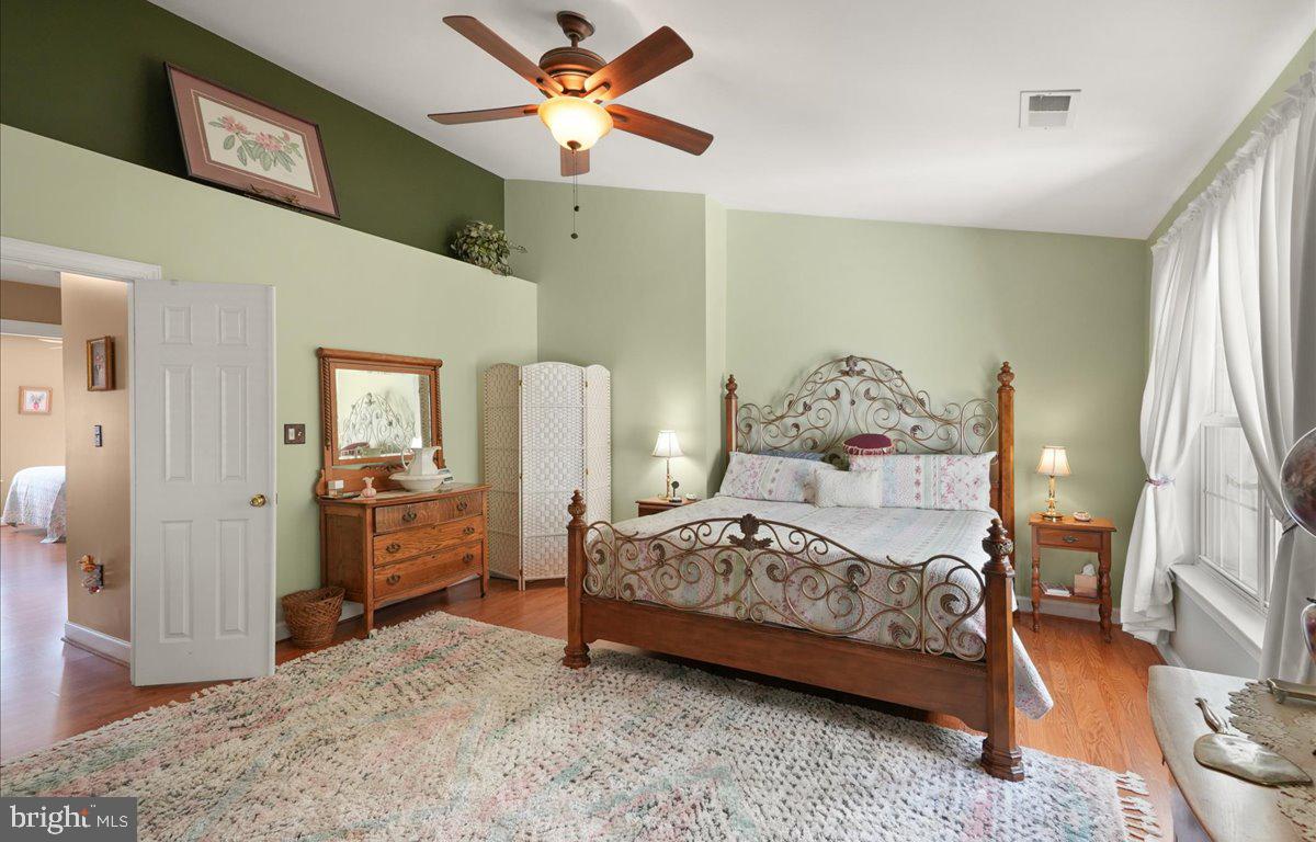 9199 Furey Road Lorton, VA 22079 - Photo 23 of 44 a bedroom with a bed and a chandelier
