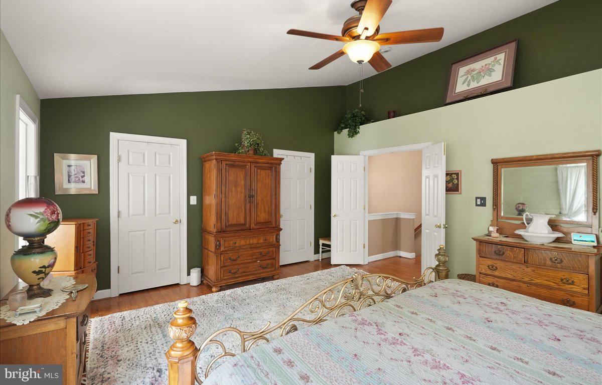 9199 Furey Road Lorton, VA 22079 - Photo 24 of 44 a bedroom with a bed and a chandelier