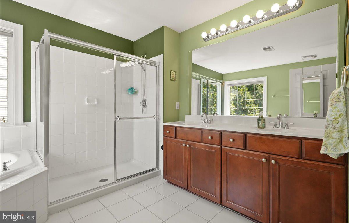 9199 Furey Road Lorton, VA 22079 - Photo 25 of 44 a bathroom with a shower sink and mirror