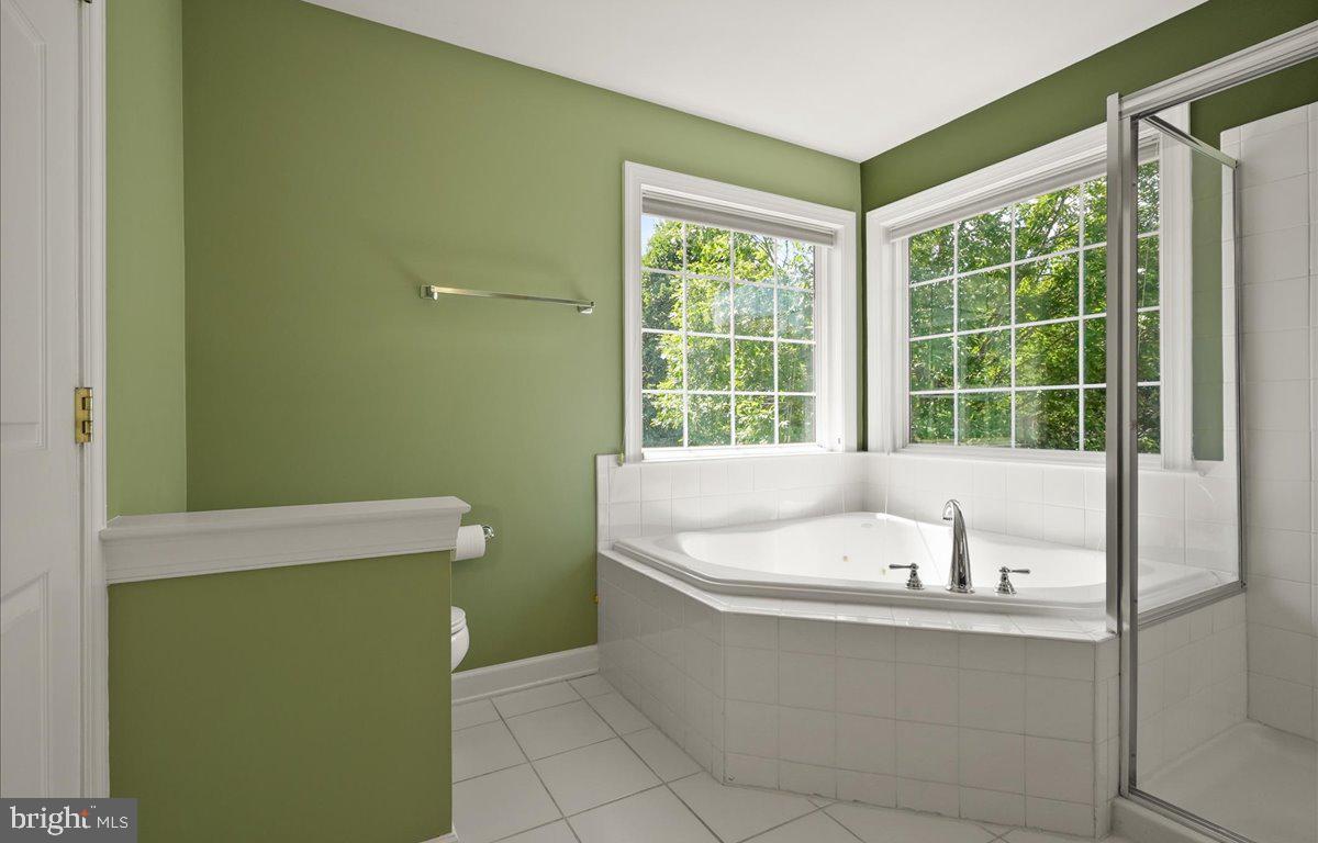 9199 Furey Road Lorton, VA 22079 - Photo 27 of 44 a bathroom with a bathtub and a shower