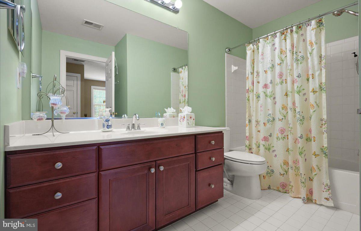 9199 Furey Road Lorton, VA 22079 - Photo 32 of 44 a bathroom with a double vanity sink toilet and shower