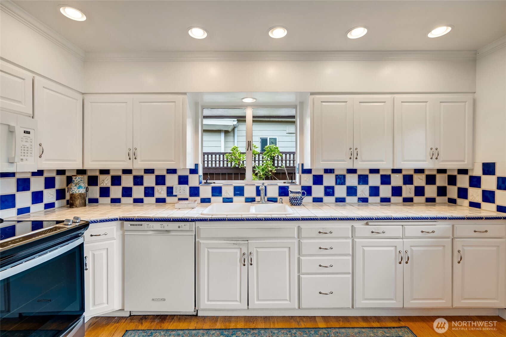 811 Rucker Avenue Everett, WA 98201 - Photo 13 of 34 a kitchen with white cabinets and sink