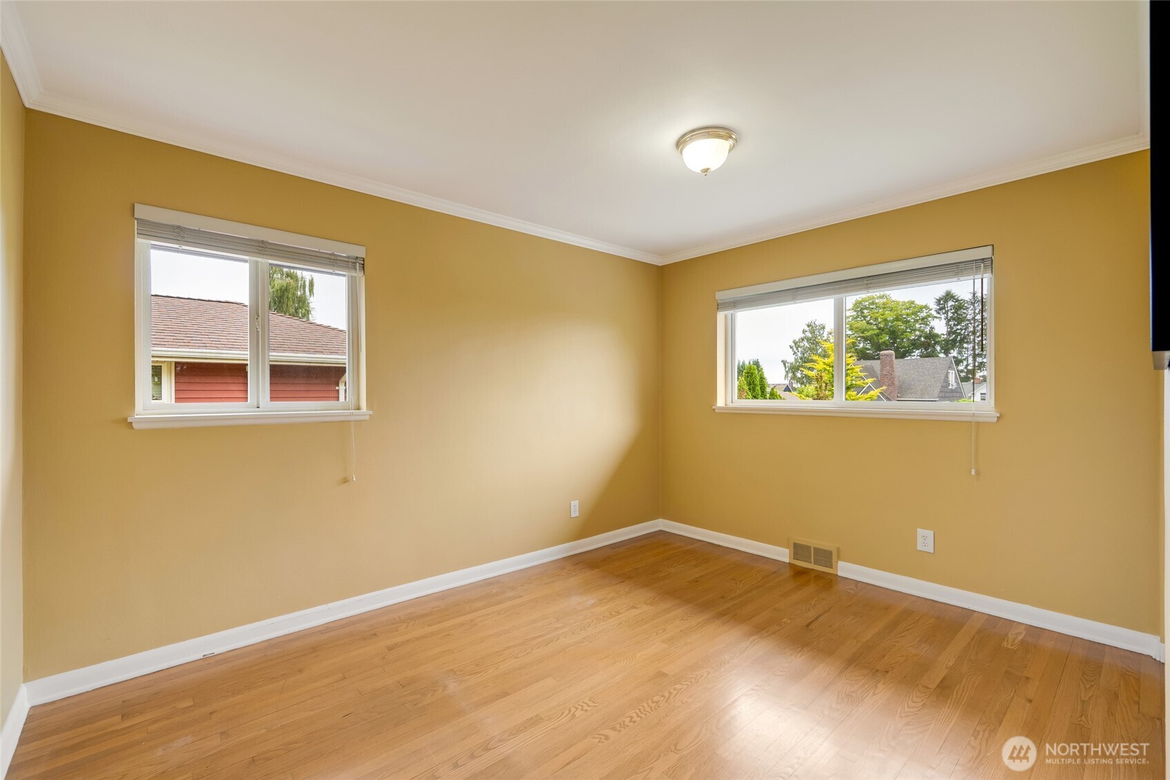 811 Rucker Avenue Everett, WA 98201 - Photo 17 of 34 a view of an empty room with wooden floor and a window