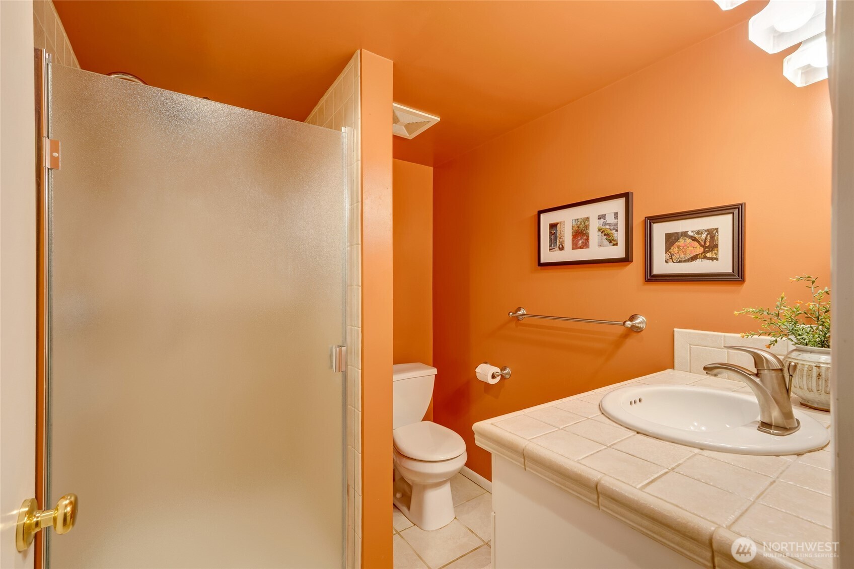 811 Rucker Avenue Everett, WA 98201 - Photo 23 of 34 a bathroom with a sink a toilet and mirror