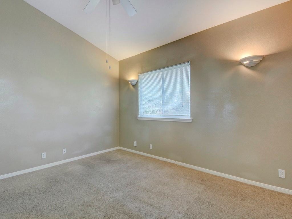 2502 Leon Street, Unit 102 Austin, TX 78705 - Photo 13 of 14 an empty room with a fan & a lamp