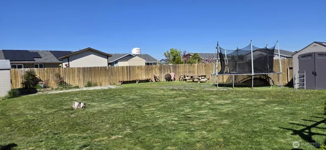 a view of a house with a yard and sitting area