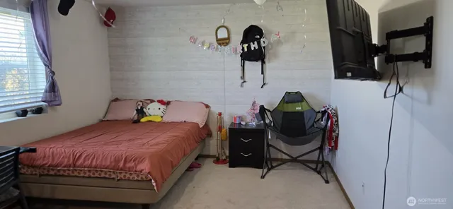 a bedroom with a bed and a dresser in it