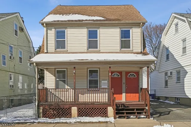 a front view of a house with a iron gate