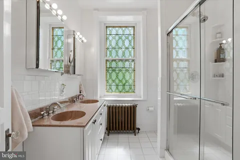 a bathroom with a sink a toilet and a shower
