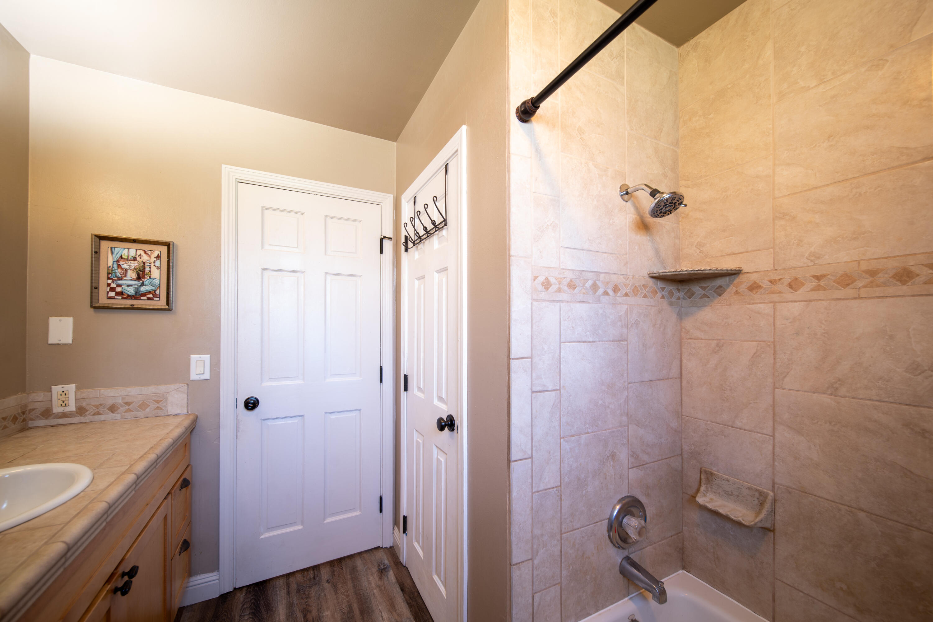 44040 Skyline Drive Three Rivers, CA 93271 - Photo 21 of 40 a bathroom with a granite countertop sink a mirror and a shower