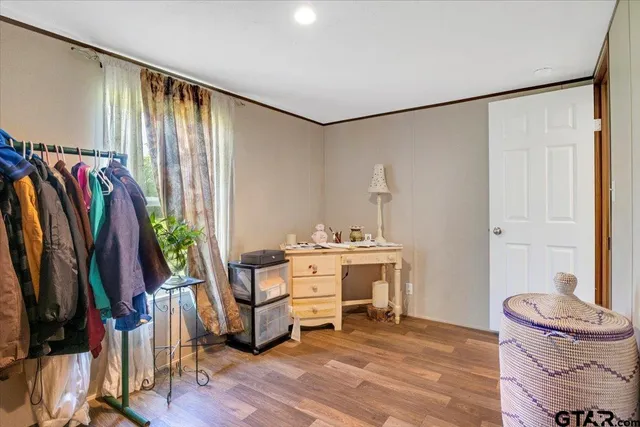 a large white house with a big yard and large trees