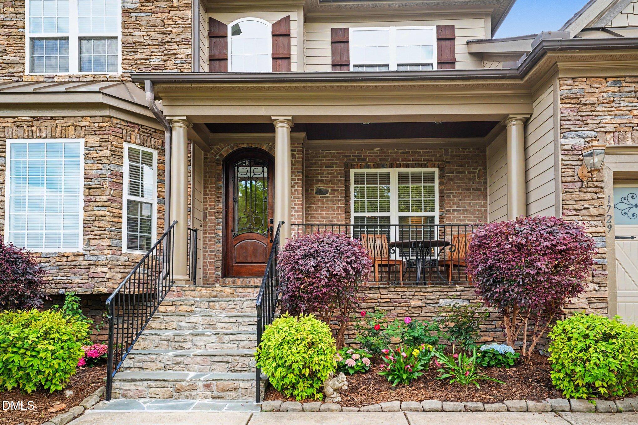 1729 Frenchwood Drive Raleigh, NC 27612 - Photo 46 of 46 front view of a house with a large window and potted plants