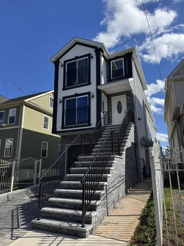 a front view of a house with wooden stairs