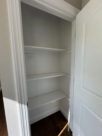 a view of walk in closet with empty racks