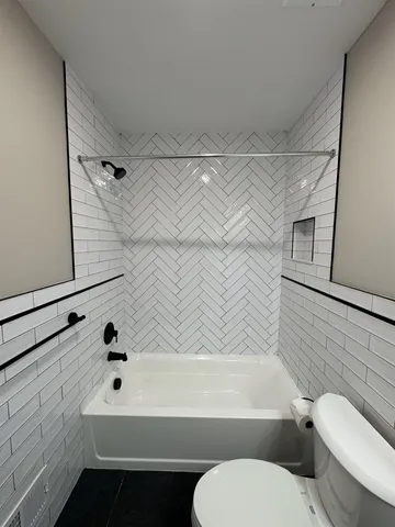 a bathroom with a toilet sink vanity and mirror