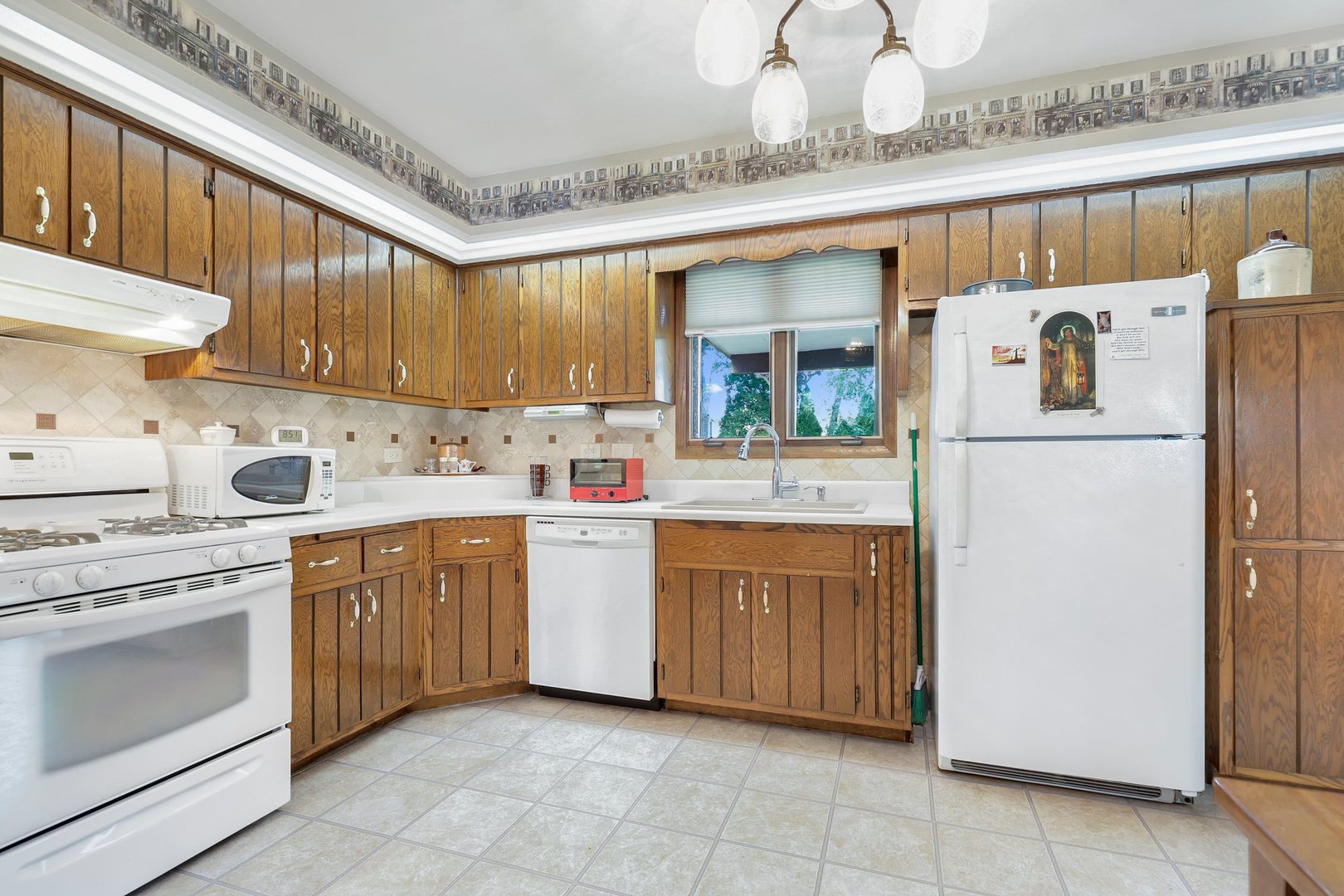 10900 Bryant Road Mokena, IL 60448 - Photo 4 of 14 a kitchen with granite countertop appliances a sink and a refrigerator