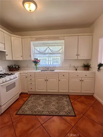 a kitchen with a sink window and cabinets