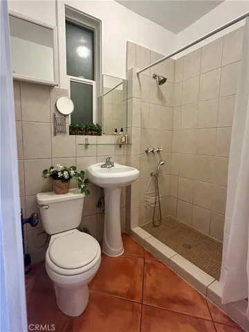 a bathroom with a toilet sink and shower