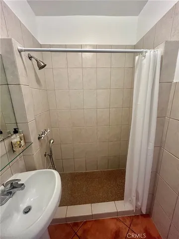 a bathroom with a shower and a sink