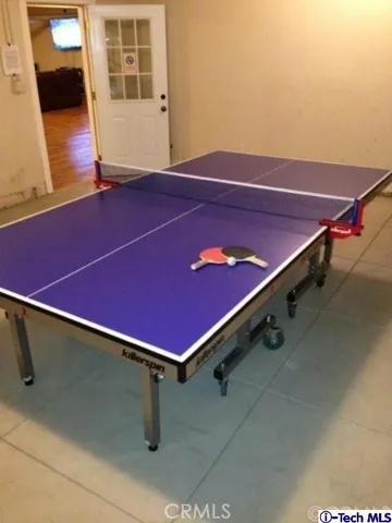 a view of a living room with a piano and wooden floor