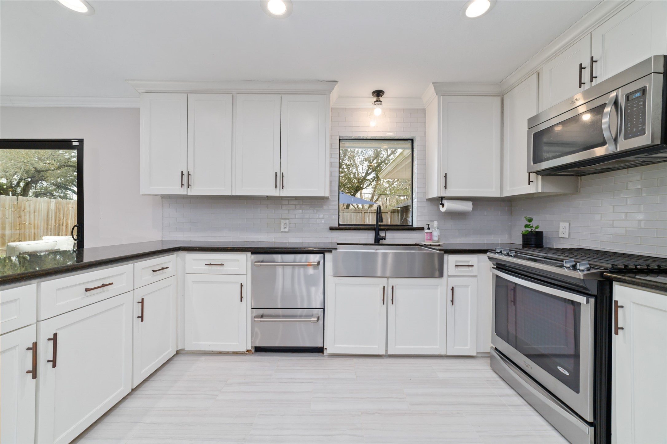 10607 Chimney Rock Road Houston, TX 77096 - Photo 11 of 35 You’re not staring at a wall in here… you’re looking straight out to the pool and backyard while you cook. Natural light during the day, task lighting when you need it, and a setup that actually makes you want to be in the kitchen. Cooking, cocktails, people drifting in and out… it all happens right here without missing anything.