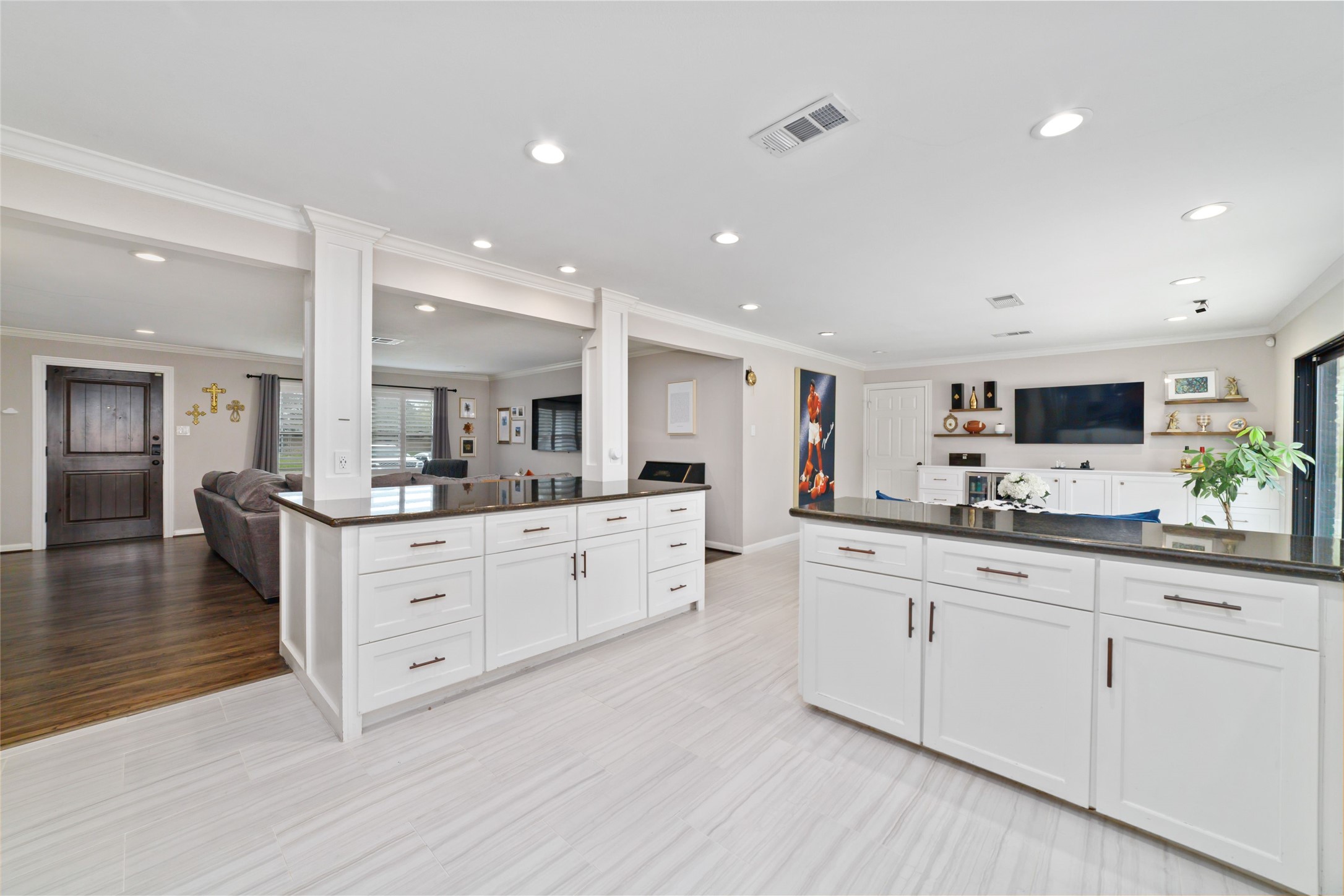 10607 Chimney Rock Road Houston, TX 77096 - Photo 15 of 35 Deep island, almost 8 feet, with room for barstools where your knees actually fit. USB plugs built into the columns so you can charge right there, and task lighting over the island on dimmers for day to night. Plenty of counter space on both sides, so you can prep, serve, and host without it getting crowded.