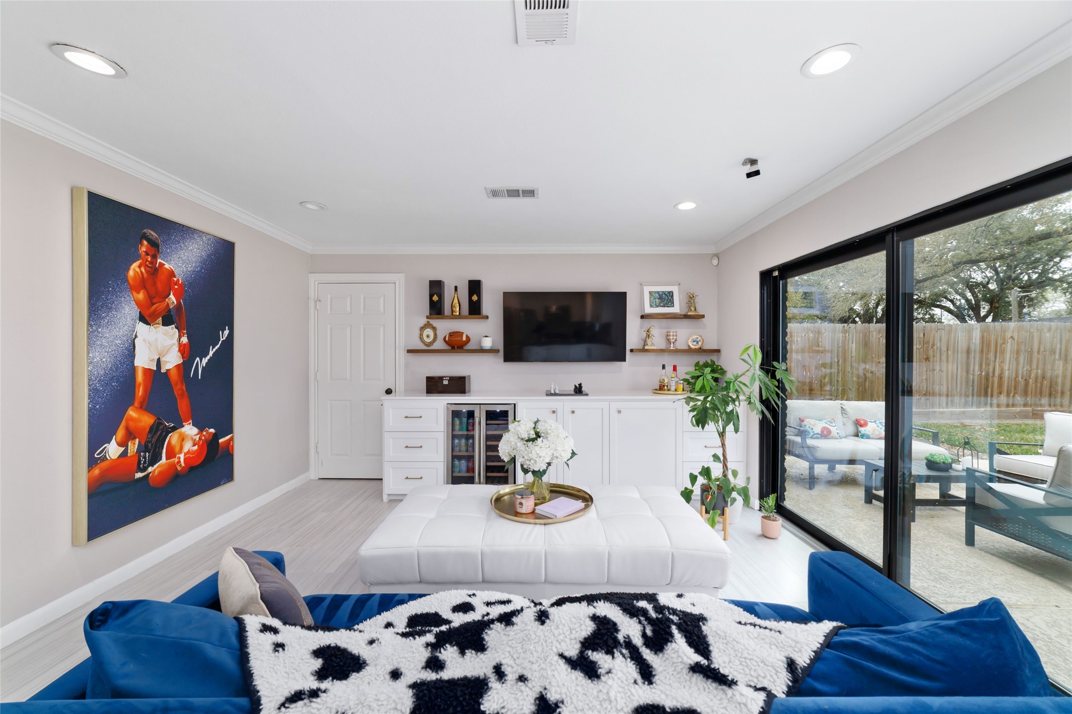 10607 Chimney Rock Road Houston, TX 77096 - Photo 18 of 35 Custom built-ins run the wall with a dual-zone mini fridge, quartz counters, and a clean drop spot for keys, mail, and everyday stuff. Recessed lighting keeps it bright, porcelain floors keep it easy, and everything has a place so it stays that way. Through that door is your indoor laundry, right where you want it without being in the way.