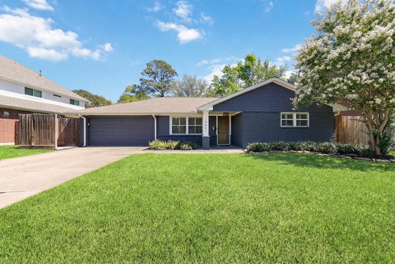 10607 Chimney Rock Road Houston, TX 77096 - Photo 2 of 35 Crisp curb appeal with a modern edge. Fresh paint, clean lines, and a yard that actually gives you space to enjoy it.