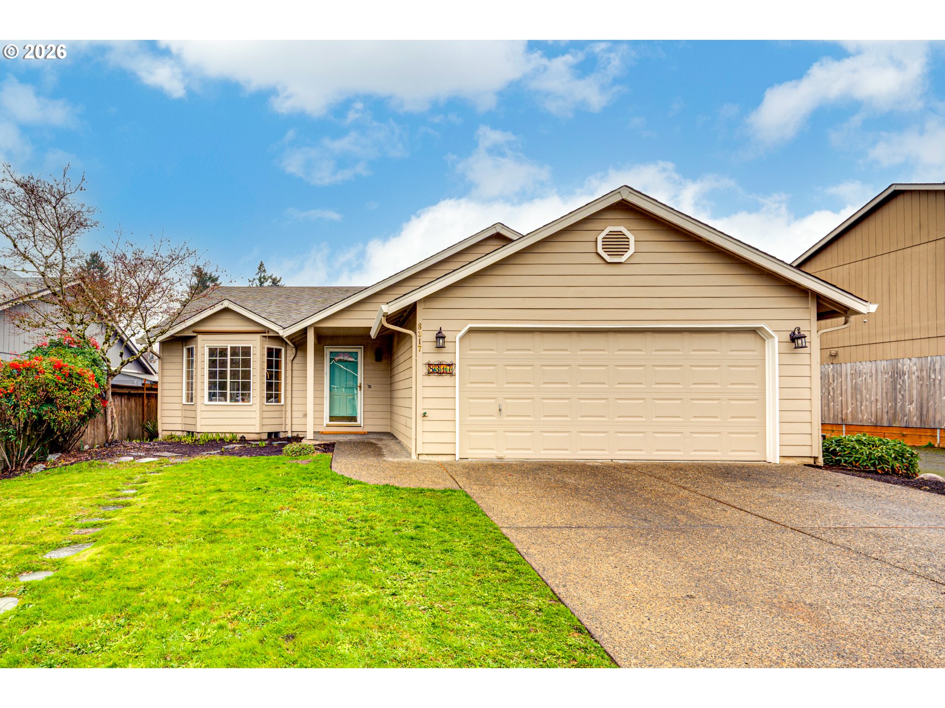 a front view of a house with a yard and garage