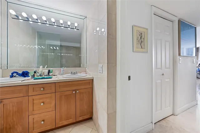 a bathroom with a sink shower and a mirror
