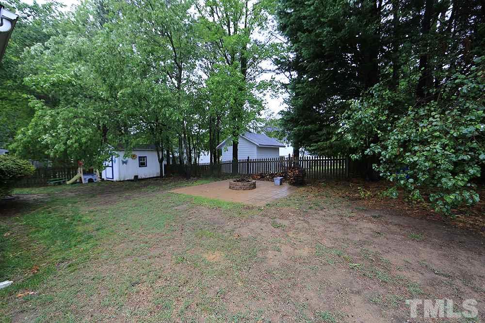 409 Flagg Road Holly Springs, NC 27540 - Photo 12 of 14 Enjoy the fenced backyard with new fire pit.