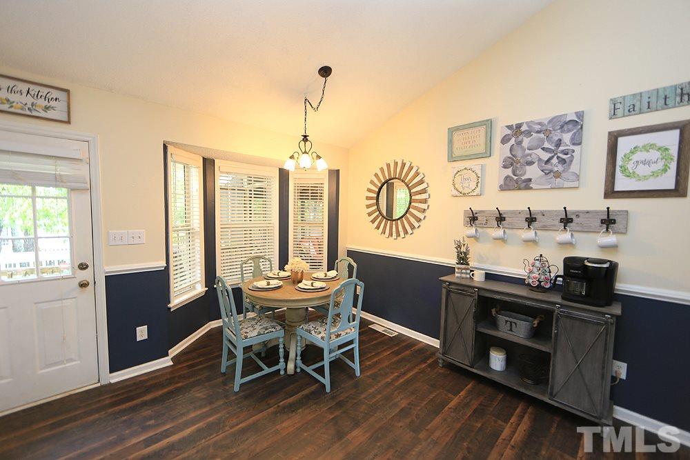 409 Flagg Road Holly Springs, NC 27540 - Photo 5 of 14 The breakfast nook features a bay window overlooking the screened porch.