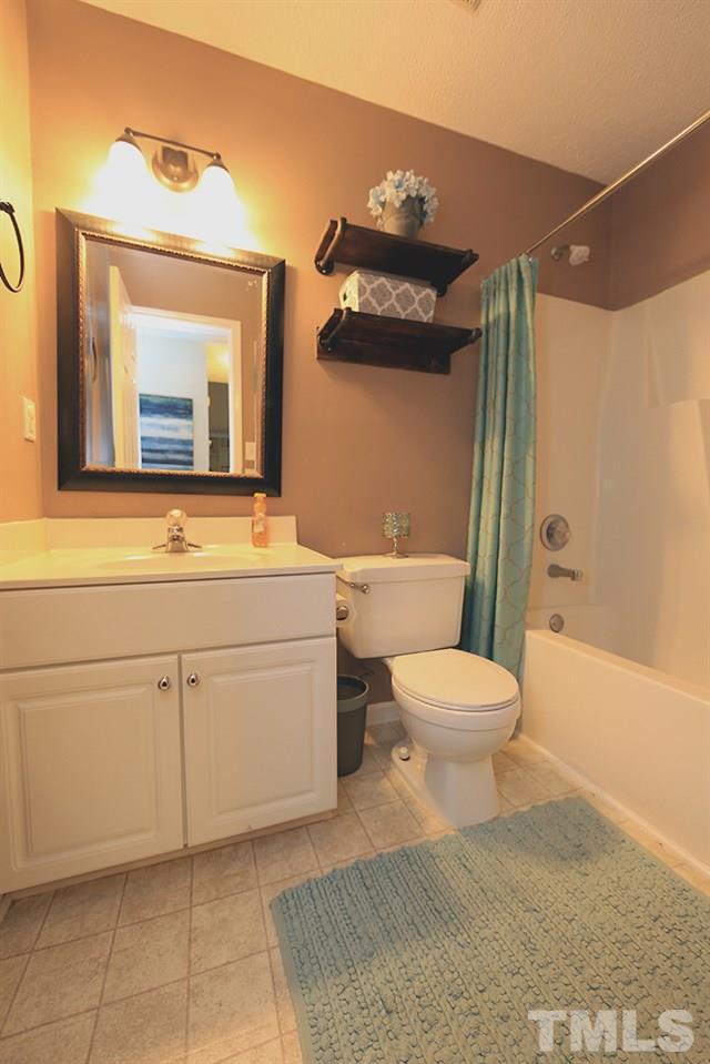 409 Flagg Road Holly Springs, NC 27540 - Photo 10 of 14 Hall bath features white cabinets and picture mirror.