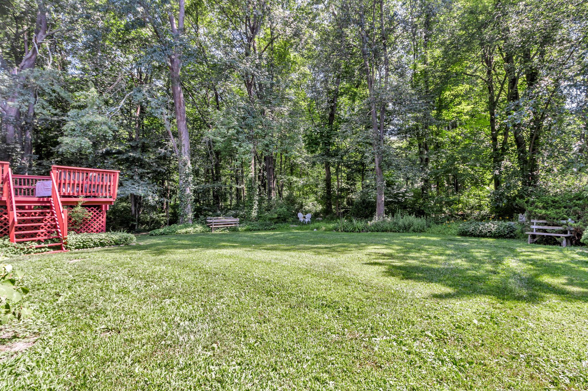14 Griffen Road Brewster, NY 10509 - Photo 22 of 30 a backyard of a house with trees and plants