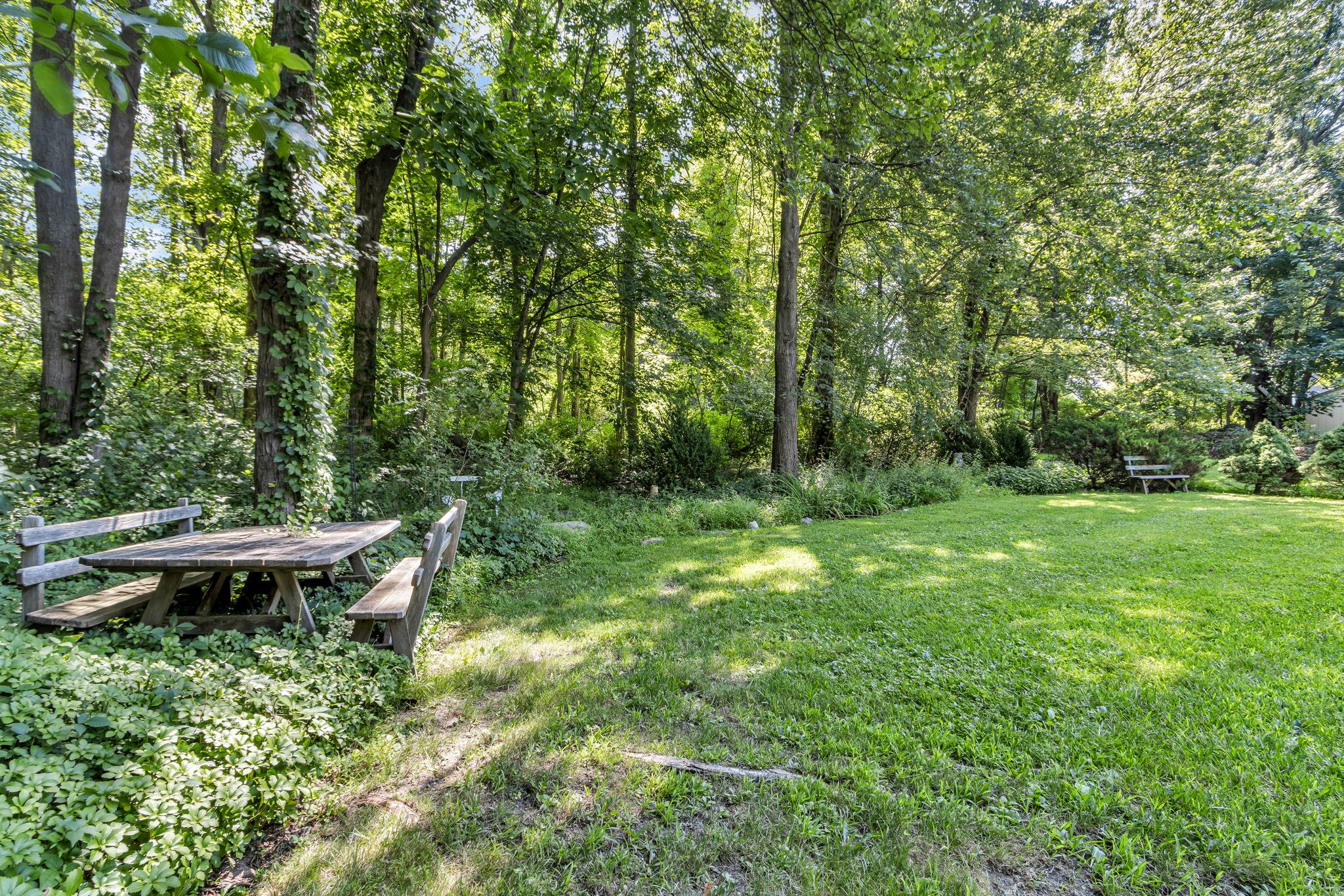 14 Griffen Road Brewster, NY 10509 - Photo 25 of 30 a view of a backyard with table and chairs and wooden fence