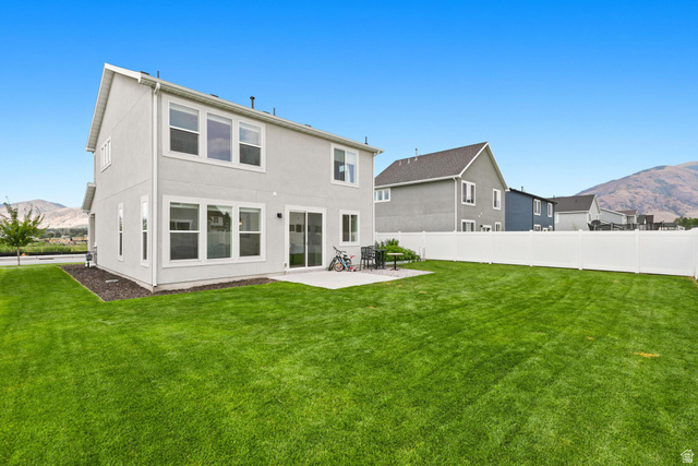 347 Ropelato Drive Logan, UT 84321 - Photo 33 of 46 Expansive green lawn with a white vinyl fence