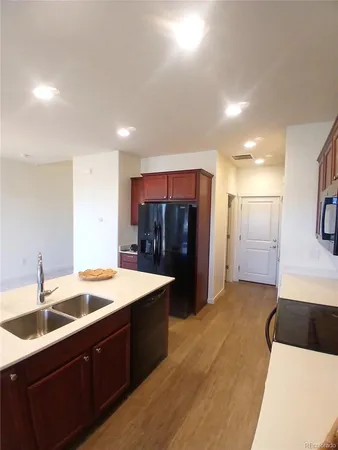a living room with stainless steel appliances kitchen island furniture and a kitchen view