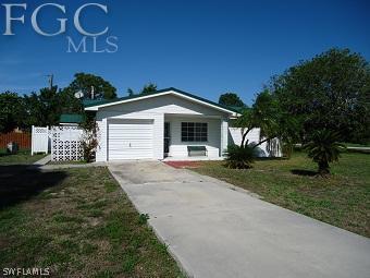 4852 Riverside Drive Estero, FL 33928 - Photo 1 of 9 a front view of a house with a yard