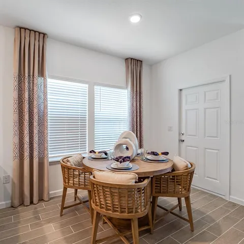 a view of a dining room with furniture and windows