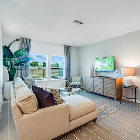 a living room with furniture and a large window