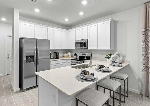 a living room with furniture a flat screen tv and a potted plant