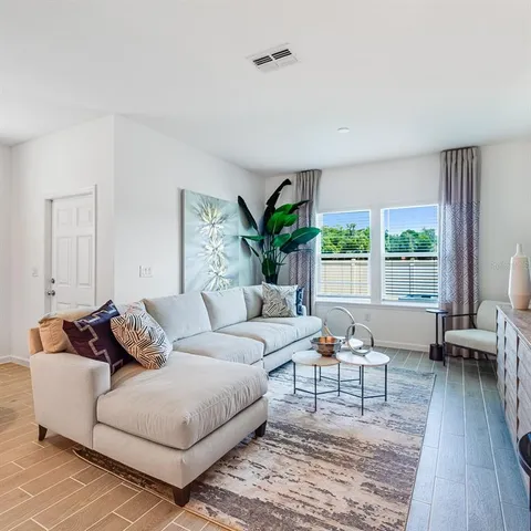 a living room with furniture and a large window